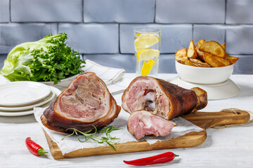Smoked pork knuckle, ham hock on cutting board