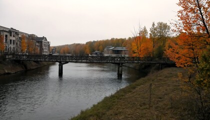 A bridge over a river with trees and buildings on either side.