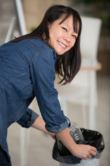 woman throwing rubbish in the office