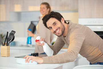 Fototapeta premium happy man cleaning the kitchen