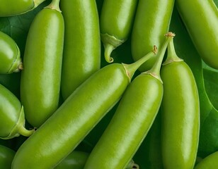 Fresh green pearl beans arranged on vibrant green leaves.
