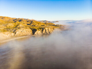 Sea with morning fog over water.