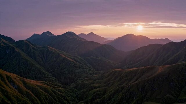 A colorful sunrise over a mountain range, casting golden light on the panoramic landscape filled with lush nature.
