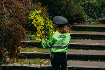 The little boy in the park dressed as a policeman