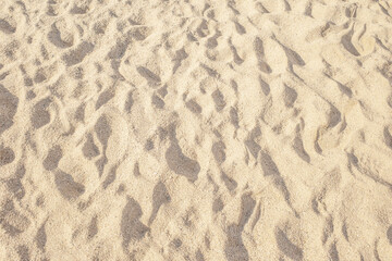 Summer beach sand background with natural wave pattern. Sand texture. Sunny gold sandy beach wallpaper, summer concept