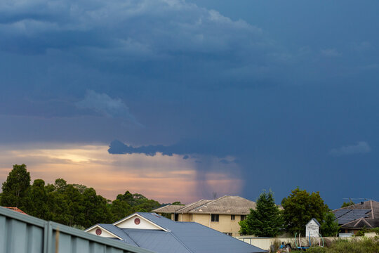 storm rolling in over suburbs with dark rain clouds in the sky