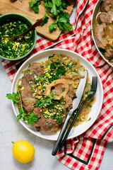 Traditional Italian Ossobuco with Gremolata and  polenta in a bowl.style huggr