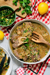 Traditional Italian Ossobuco with Gremolata and  polenta in a bowl.style huggr