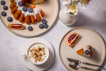 Delicious cake with blueberries and a cup of cappuccino enjoyed for breakfast