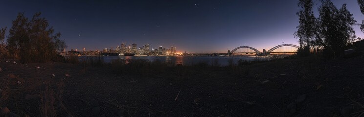 Obraz premium Panoramic view of city skyline Bridge at night, clear sky, no clouds, no buildings in front of or near the bridge, no reflections on the water surface, sharp focus