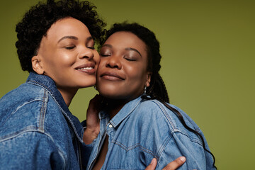 Fototapeta premium Stylish lesbian couple sharing a loving embrace in vibrant attire