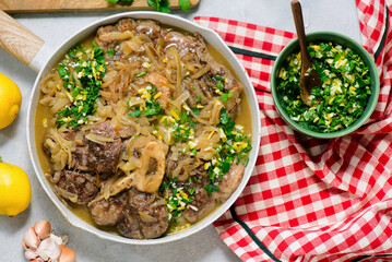 Traditional Italian Ossobuco with Gremolata and  polenta in a bowl.style huggr