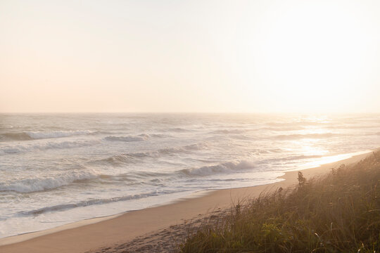 Sun setting over calm ocean and Cisco Beach