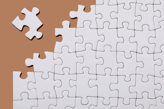 Studio shot of white jigsaw puzzle pieces