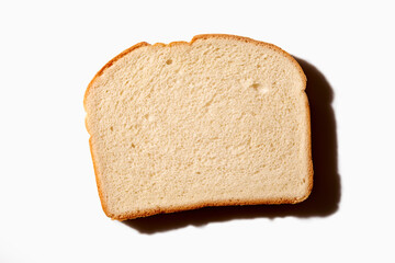 Overhead view of slice of white bread on white background