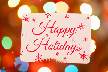 Christmas gift card with colorful lights in background