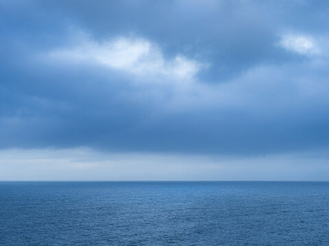 Storm clouds over calm sea