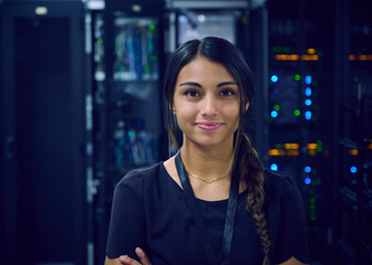 Portrait of smiling female technician in server room 