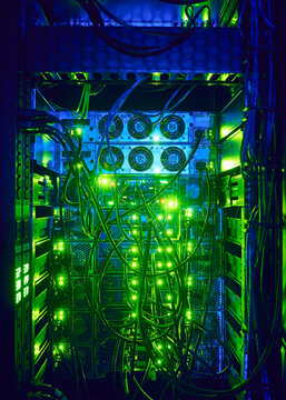 Close-up of hard drives and cables in data center