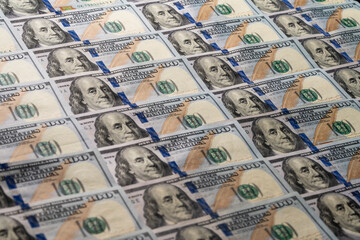 Background of many american one hundred dollar banknotes. A pile of new one hundred US dollars. Cash of hundred dollar bills, closeup