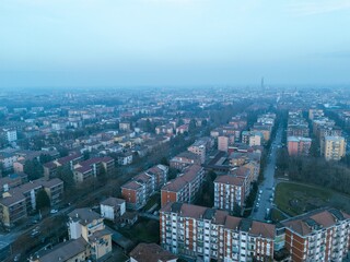 Obraz premium Cremona skyline in winter, featuring the Torrazzo bell tower, viewed from above at sunset