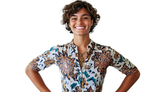 A woman wearing a floral shirt stands confidently with her hands on her hips, exuding a sense of empowerment and style