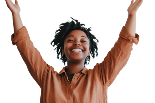 A woman joyfully raises her arms in the air, expressing happiness and freedom