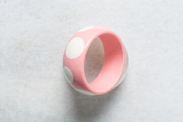 Overhead view of vintage pink bangles, top view of vintage plastic pink bangles on a white background