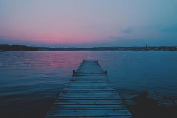 Fototapeta premium Reflections of poles from an old wharf with a heritage background, taken in blue or golden hour