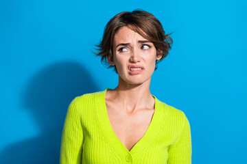 Photo of unsatisfied displeased girl grinning teeth look arrogant empty space isolated on blue...