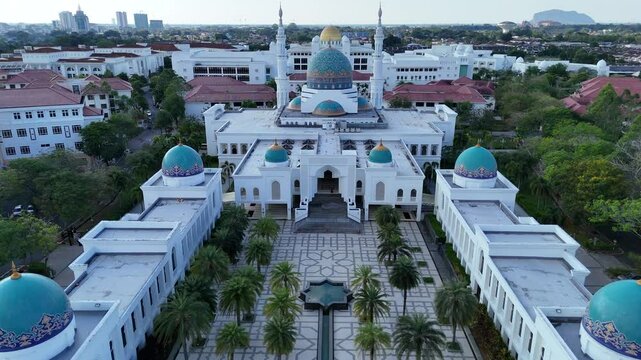 Aerial view of Masjid AlBukhary in Alor Setar, Malaysia &ndash; stunning Islamic architecture with blue domes, symmetrical design, and surrounding greenery.