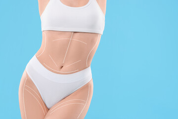 Plastic surgery. Woman with perfect slim body on light blue background, closeup. Figure correction...