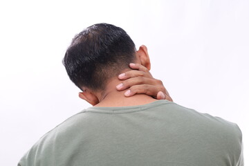 Fototapeta premium Close up photo of Asian man with neck pain back view holding neck on white background