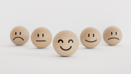 Customer service evaluation, feedback, and satisfaction survey concept. Wooden BALL blocks with a cute smiley emoticon with emotion faces on white background with copy space.