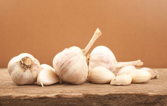 Set of garlic on old wooden table with brown background