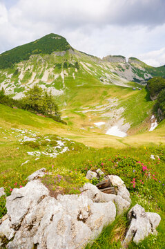 Vertical shot of beautiful Austrian hills under the cloudy sky