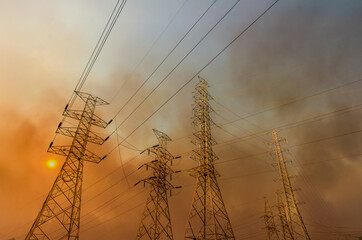 Wildfire is burning near power transmission tower line.