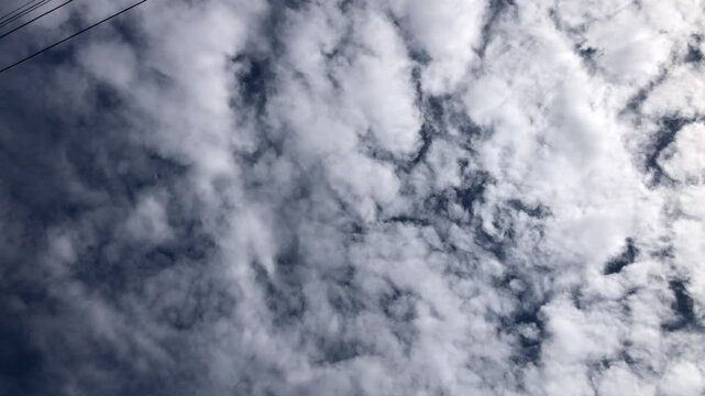 Clouds cumulus cloudscape, white fluffy, scenic sunlight, climate on clear blue sky, selective focus. Ant's view. Natural background.