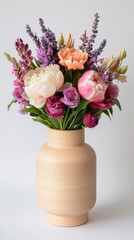 Colorful floral arrangement in a wooden vase with a variety of blooms and greenery during daylight
