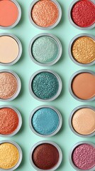 Fototapeta premium Colorful Cosmetic Palette Arrangement Eye Shadow Collection in Pastel Green Background