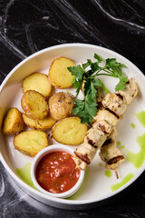 Delicious Grilled Chicken Skewers Served with Potatoes and Flavorful Sauce for Enjoyment