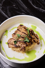 Deliciously Grilled Chicken Infused with Fresh Herbs Presented on a Minimalist Plate Design
