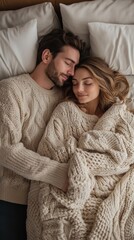 Full length of spouses sleeping together on bed, man embracing wife, couple having lazy morning in bedroom, top view