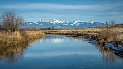 Serene River Reflection with Snow-Capped Mountains in Background