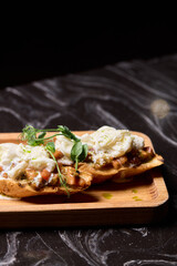 A Mouthwateringly Delicious Gourmet Dish Impeccably Served on a Rustic Wooden Plate