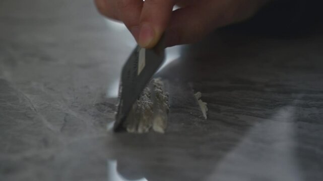 Drugs on the table close-up.
A drug addict is about to snort drugs.
Credit card and drugs on the table.
Drug trafficking theme.
Using narcotic powder