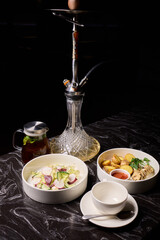 Indulge in an exquisite hookah experience accompanied by a selection of gourmet dishes to savor