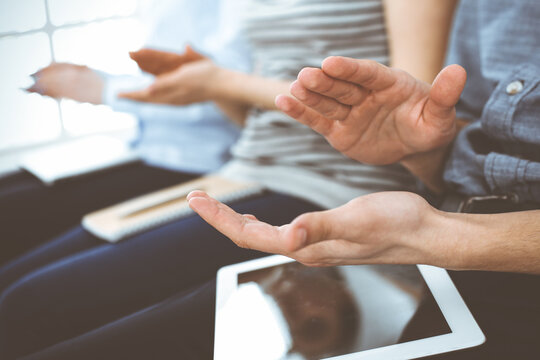 Business people clapping at meeting or conference, close-up of hands. Group of unknown businessmen and women in modern white office. Success teamwork, corporate coaching and applause concept