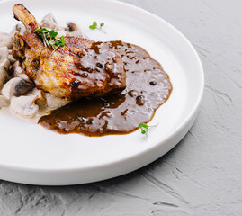 Gourmet pork chop with mushroom sauce on plate