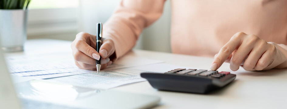 Deduction planning, debt asian young woman  hand using calculator to calculating money balance from bill and income, cost budget expenses for pay money form personal individual on table at home.